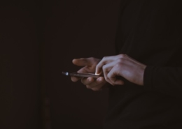 Bild von einem Mann, welcher ein Handy in der Hand hält